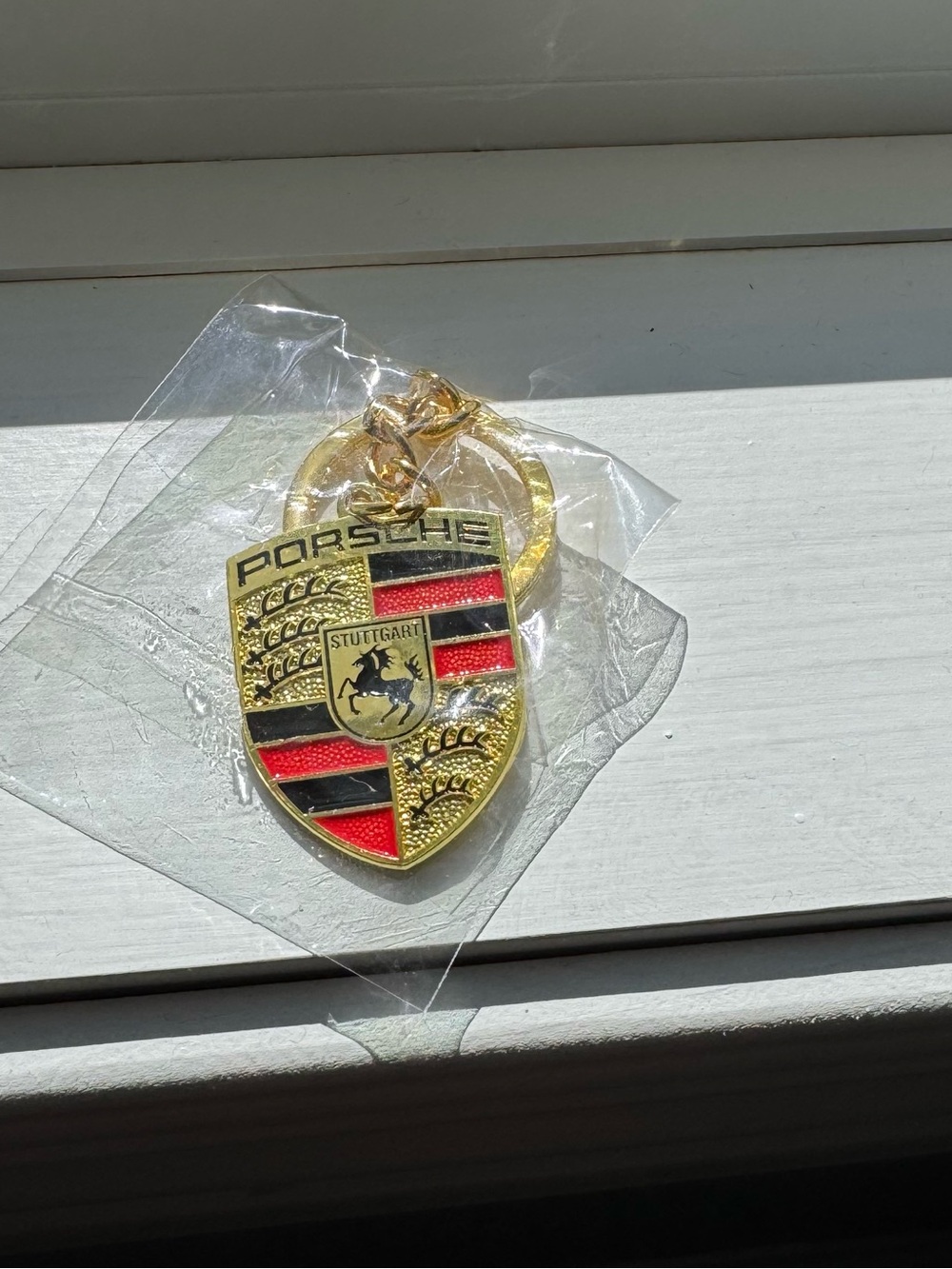 Gold & Red Crest Porsche Keychain - Branded Automotive Accessory
